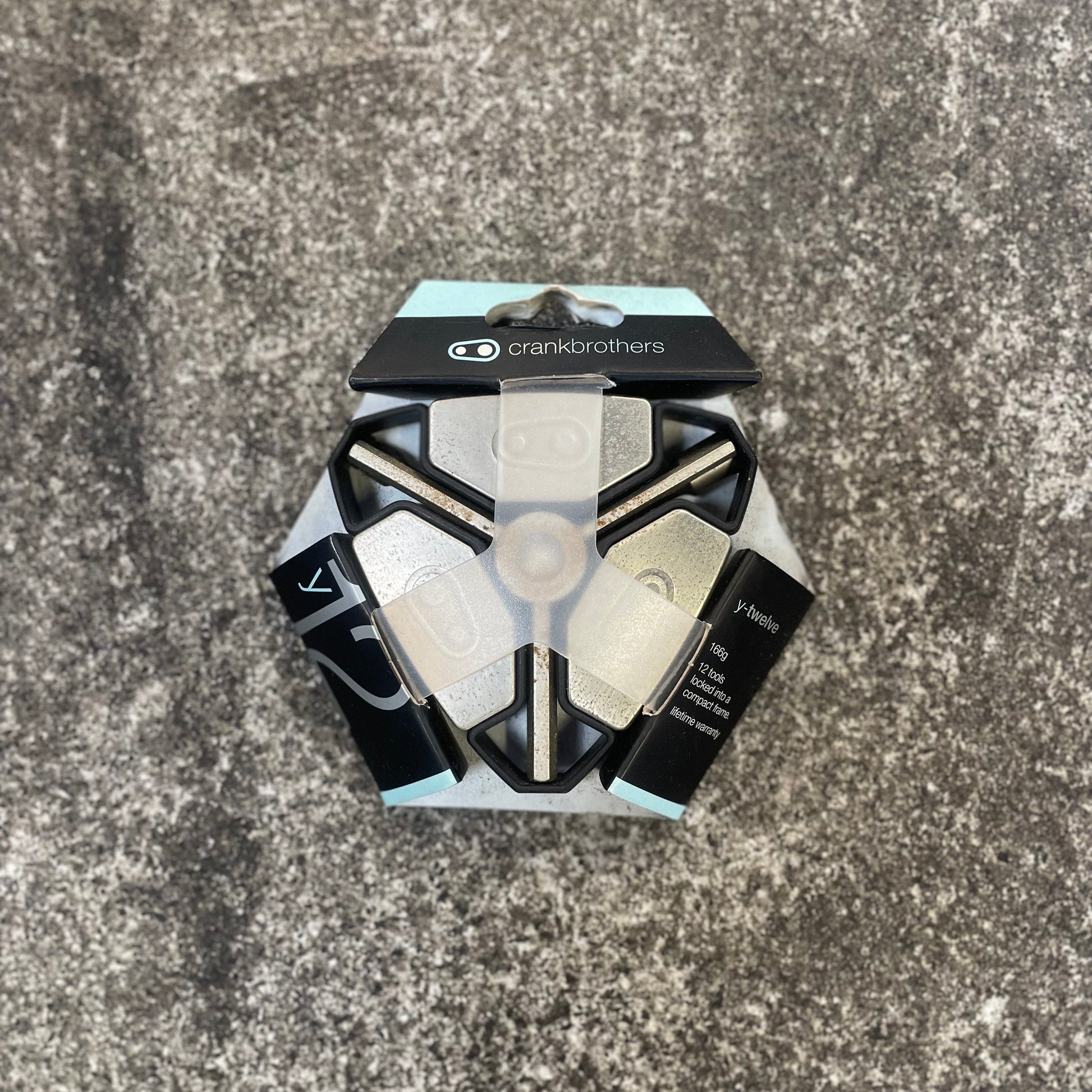 Hexagonal bike hub on a concrete surface with 'Crankbrothers' branding.