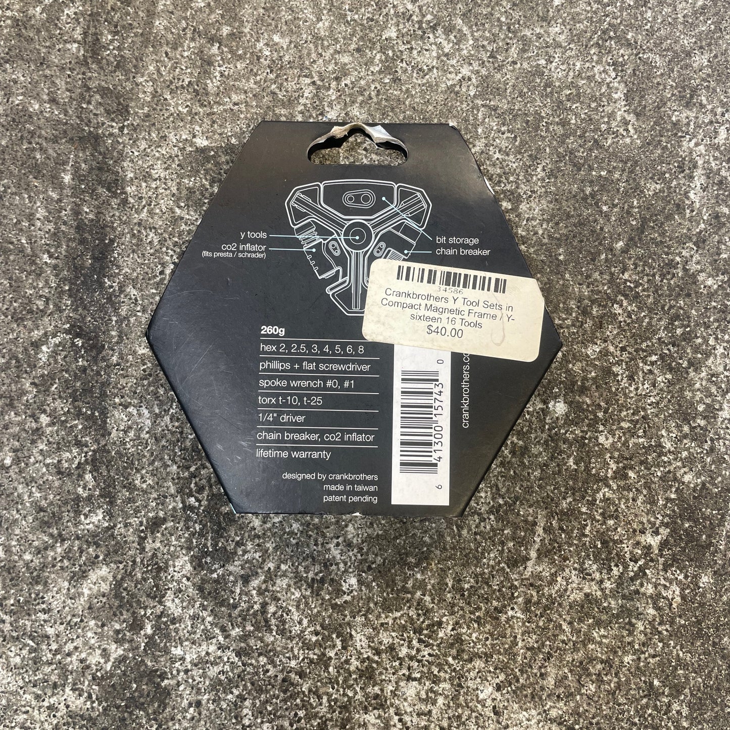 Black hexagonal object with labels on a textured gray surface